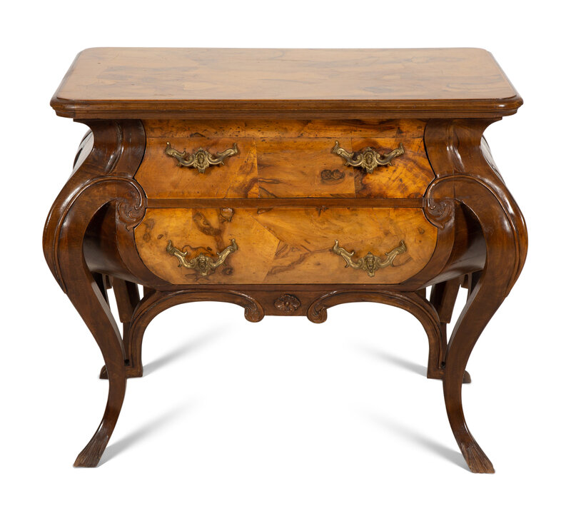 A Continental Gilt Metal Mounted Olivewood and Mahogany Bombé Commode