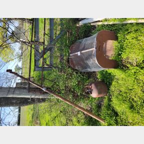Adjustable support beam, old propane tank and animal cage