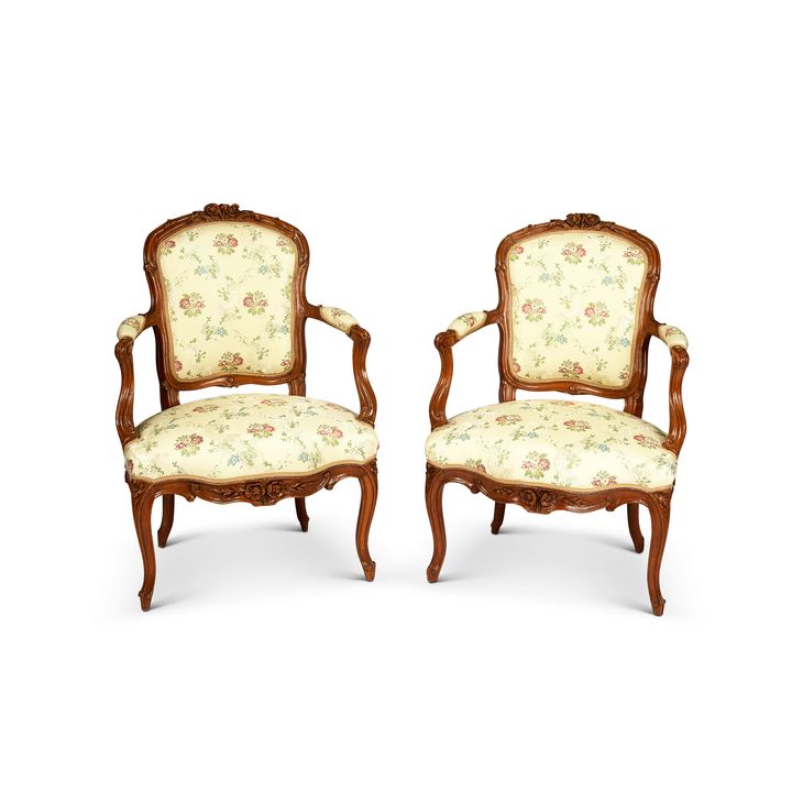 A pair of 19th century French Louis XV style walnut carved fauteuils / open armchairs