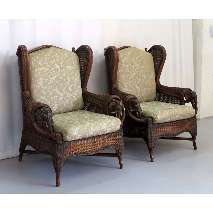 PAIR OF WICKER WINGBACK ARMCHAIRS, with carved elephant detail