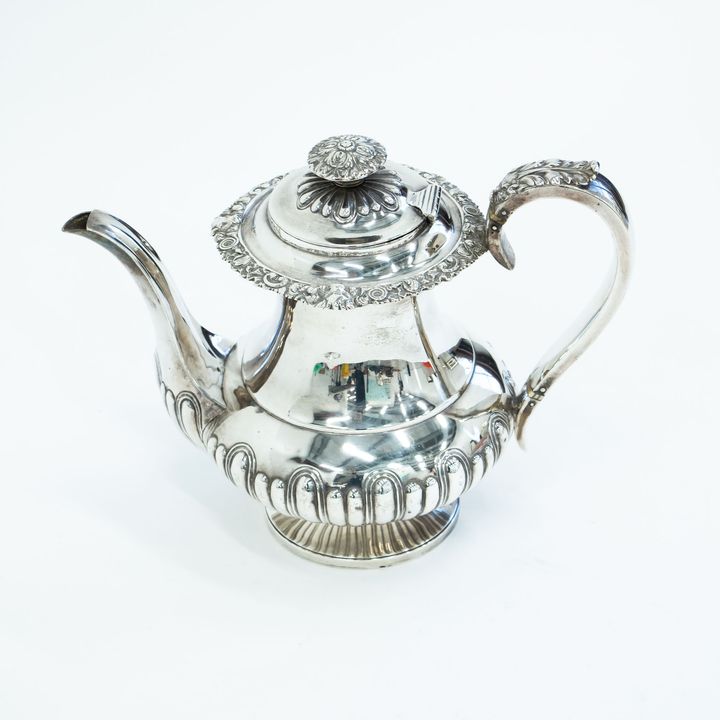 A large silver lidded hot water jug