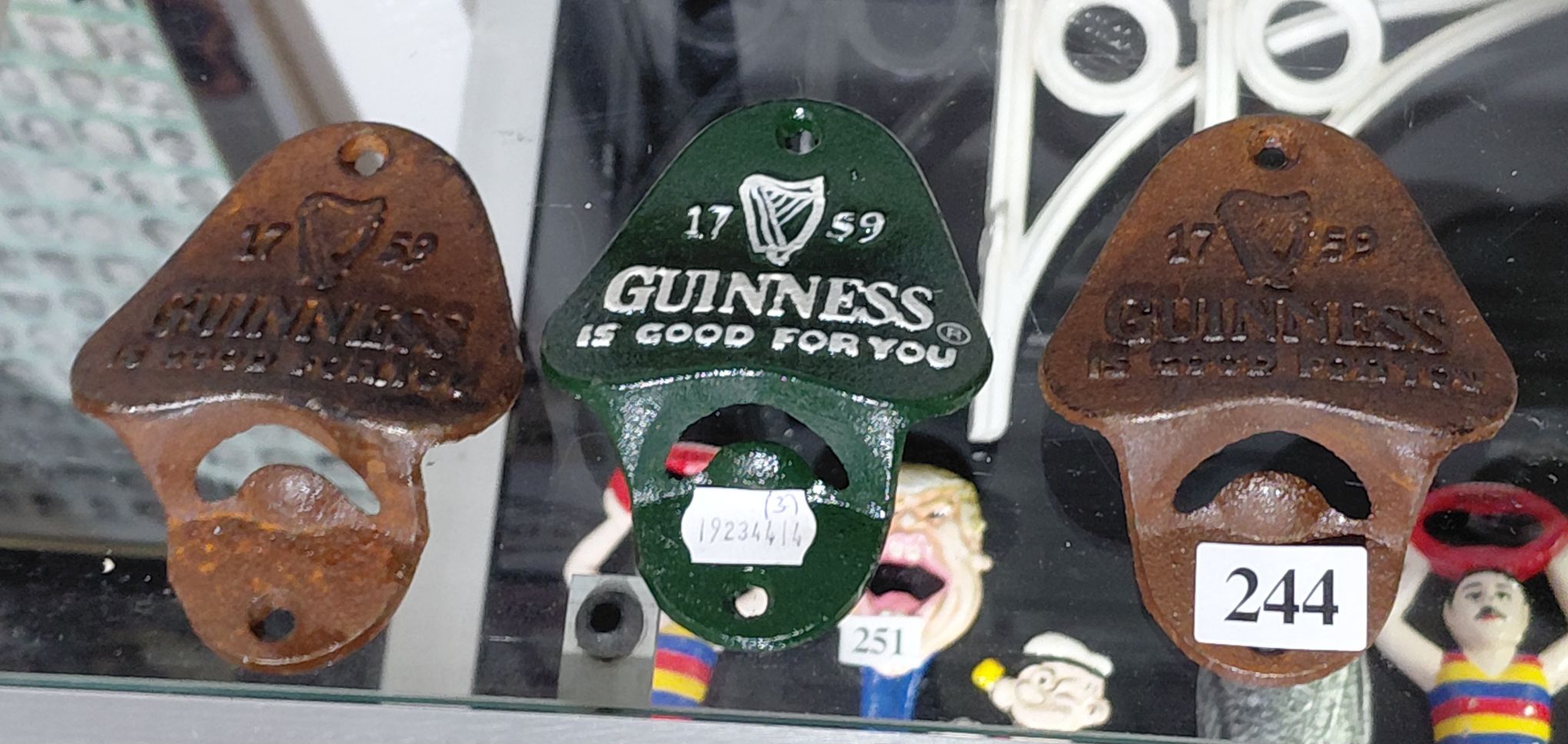 244 · 4 CAST IRON BOTTLE OPENERS