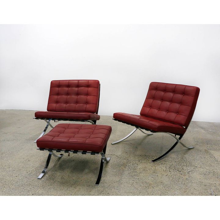 A pair of Barcelona chairs together with a single matching ottoman