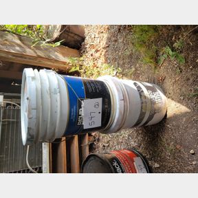 Two partial 5 gallon buckets of pinkish and gray paint