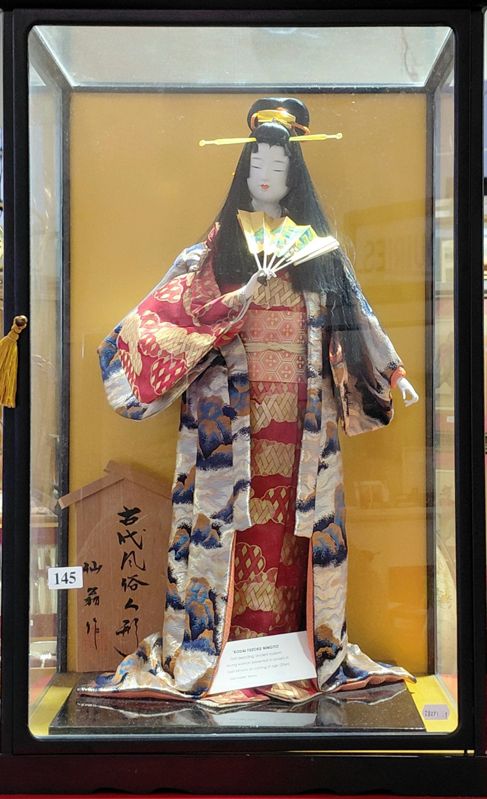 145 · JAPANESE DOLL IN CABINET