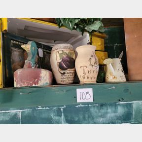 Wood duck, stone containers, other decorative items on shelf