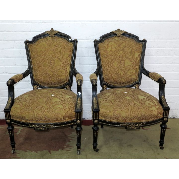 PAIR OF GILDED AND EBONIZED OPEN ARMCHAIRS