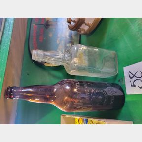 Antique Jack Daniel and other brown liquor bottles