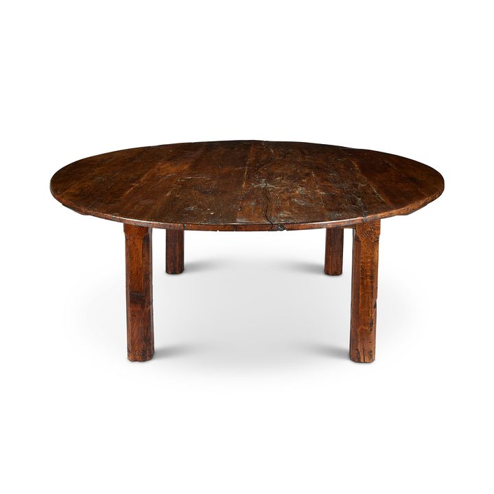 A large circular reclaimed oak dining table