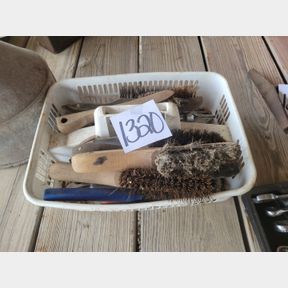 Plastic container of wire brushes and other tools
