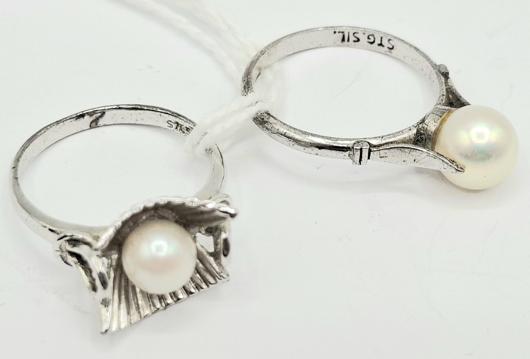 1041 · TWO STERLING SILVER PEARL RINGS