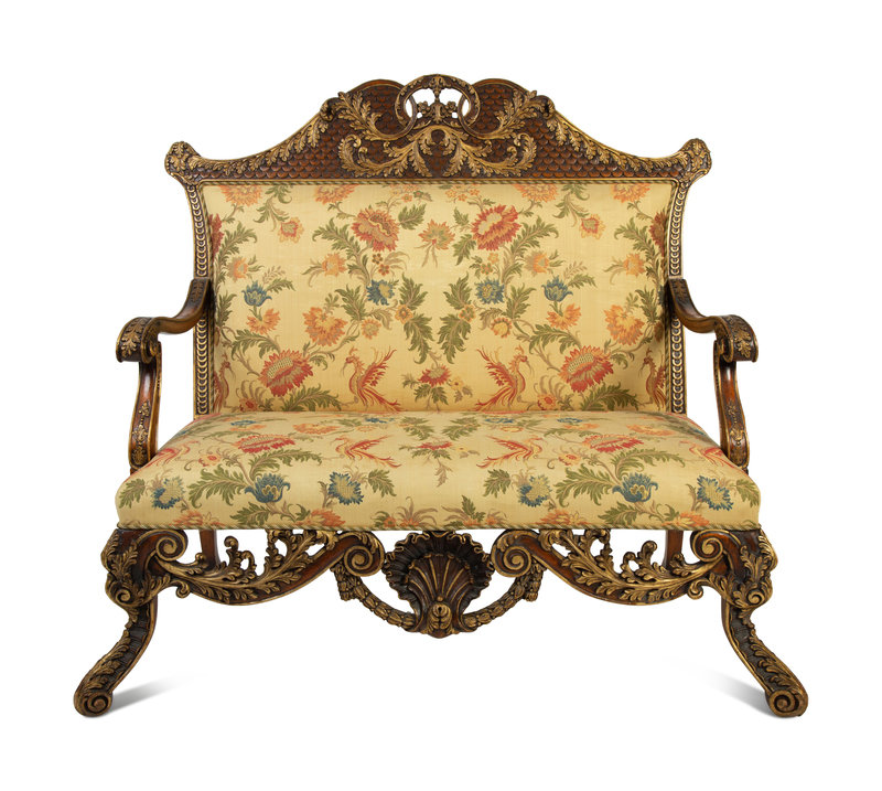 A Portuguese Carved Oak and Parcel Gilt Settee
Height 49 1/4 x width 51 x depth 31 3/4 inches.