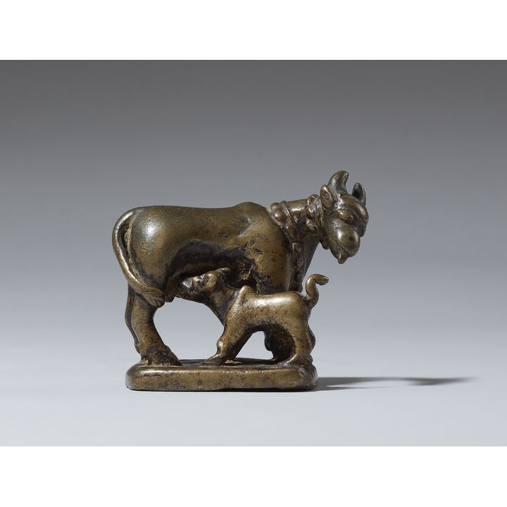 A copper alloy figure of a cow and calf. India. 17/18th century