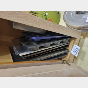 Large assortment of baking sheets and muffin pans