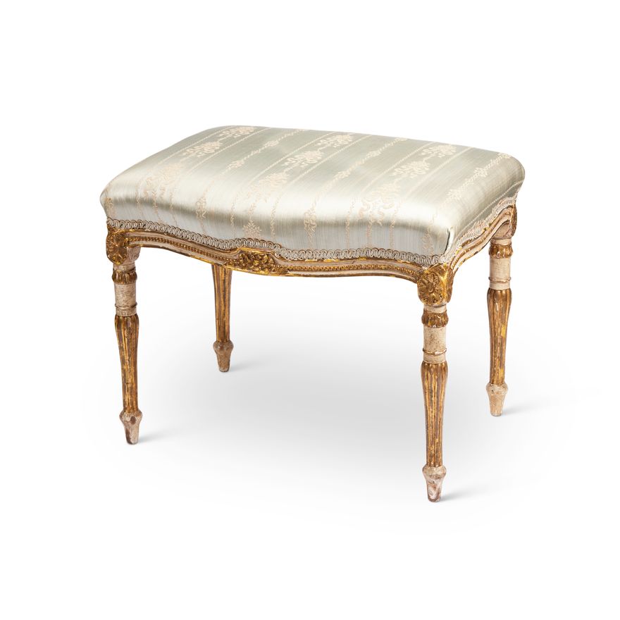 A George III white painted and parcel gilt serpentine stool