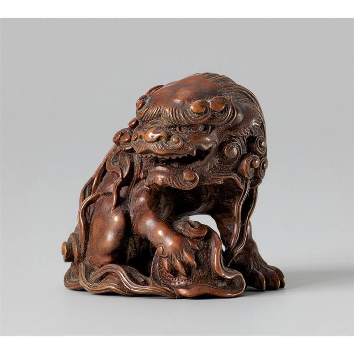 A boxwood netsuke of a shishi. 19th century