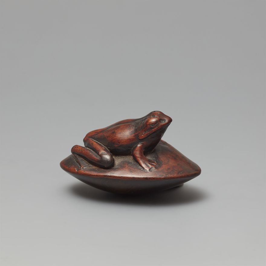 A large wood netsuke of a frog on a clam. 19th century