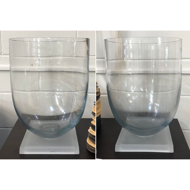 A pair of large glass vases on square frosted base