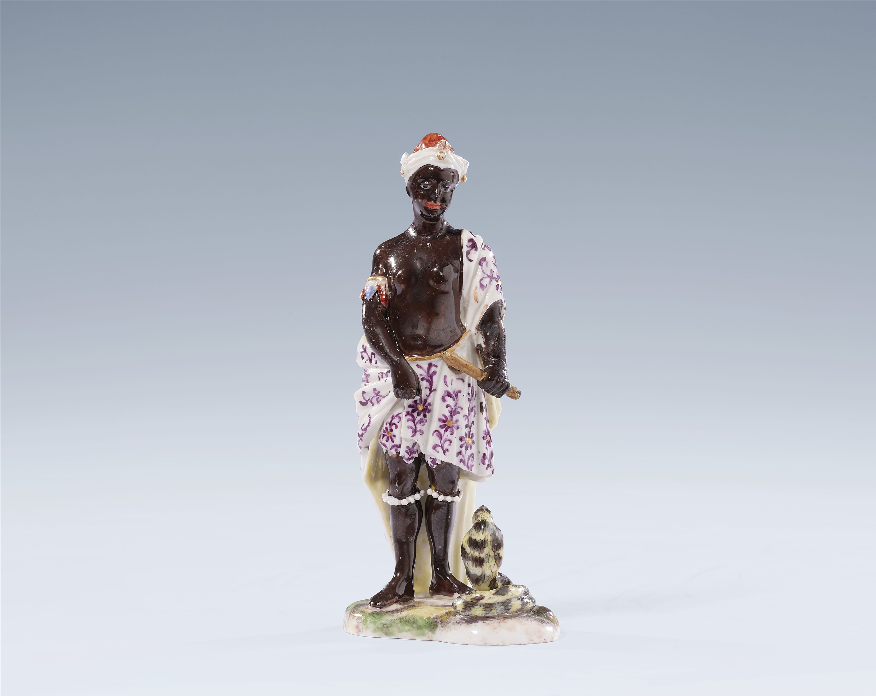 A Ludwigsburg porcelain figure of an African woman with a cobra