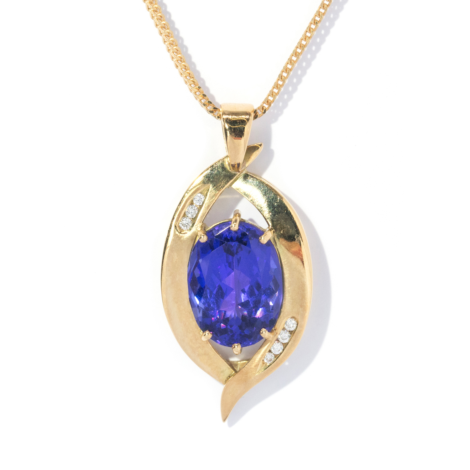 136 · 12 Carat Oval Tanzanite & Diamond Pendant & Chain in 18ct Gold