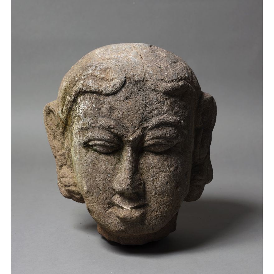 A decorative stone Buddha head sculpture