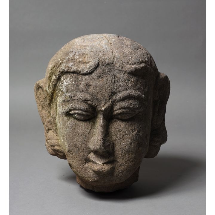 A decorative stone Buddha head sculpture