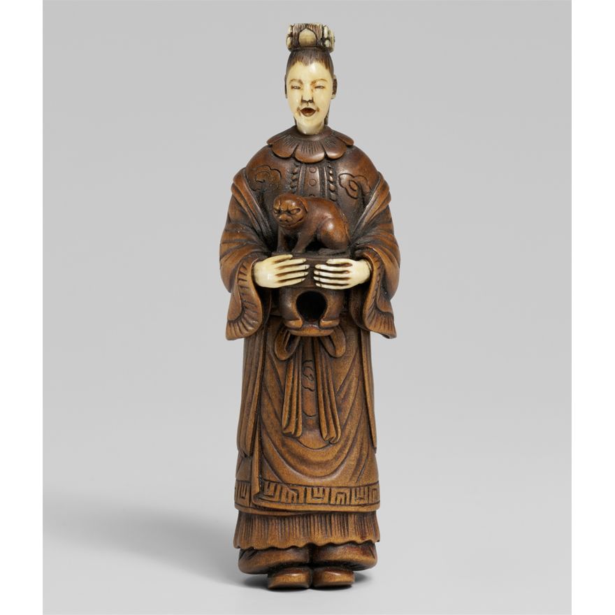 An ivory and wood shunga netsuke of a Chinese lady with a shishi. 19th century