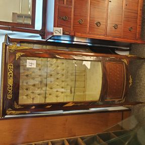 Unique old concave glass curio cabinet, padded backing
