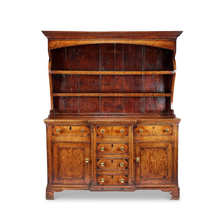 An 18th century oak and mahogany inlaid dresser, probably Angelsey