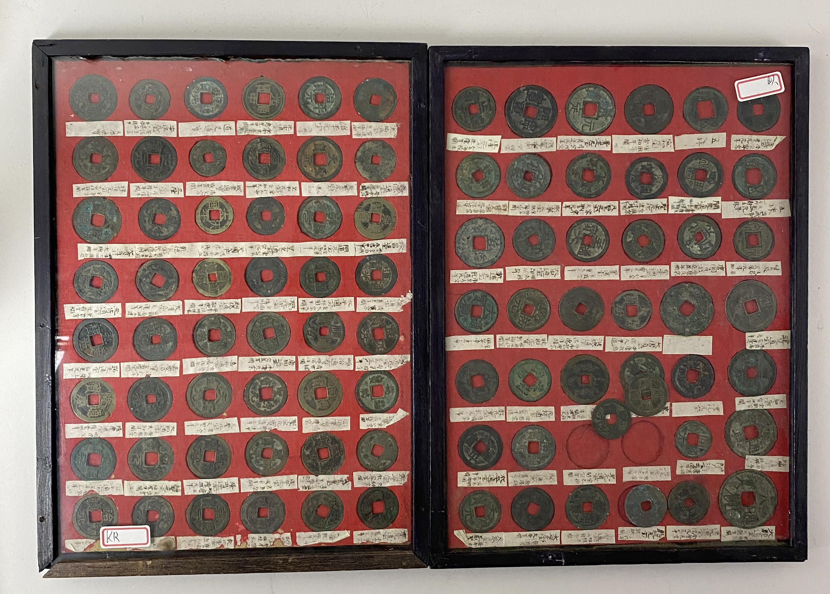 CHINA. A collection of ninety (90) cash coins. In two framed display ...