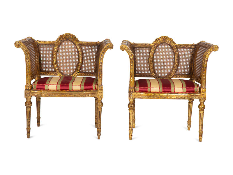 A Pair of Louis XVI Style Giltwood Cane-Back Benches 
Height 34 1/4 x width 32 1/2 x depth 18 inches.
