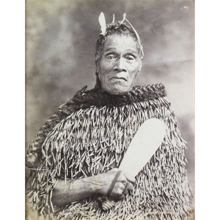 MARTIN, JOSIAH - Image of a chief wearing a rain cloak and carrying a patu
