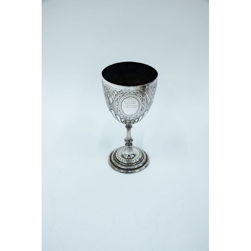 An engraved silver-plated cup
