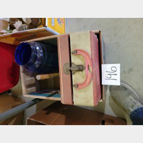 Vintage travel box, divided food trays, and blue liquid dispenser