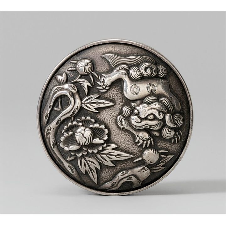 A silver two-part manju of a shishi. Second half 19th century