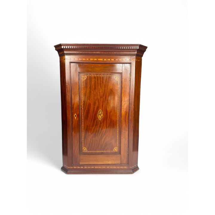 A Georgian mahogany and marquetry corner cupboard