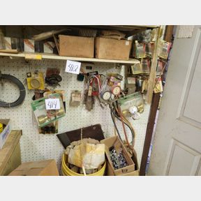 Large assortment of small nails and other items on the wall