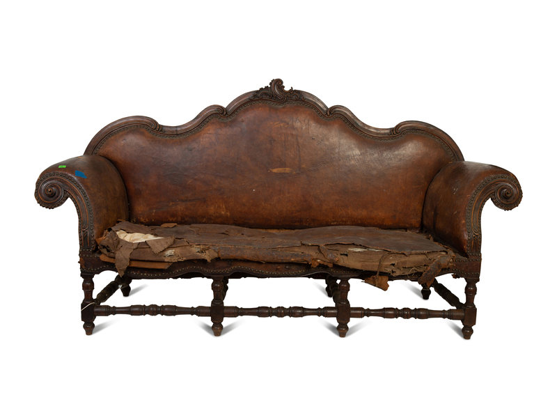 A Spanish Baroque Carved Walnut Leather-Upholstered Sofa
Height 47 x width 91 x depth 25 inches.